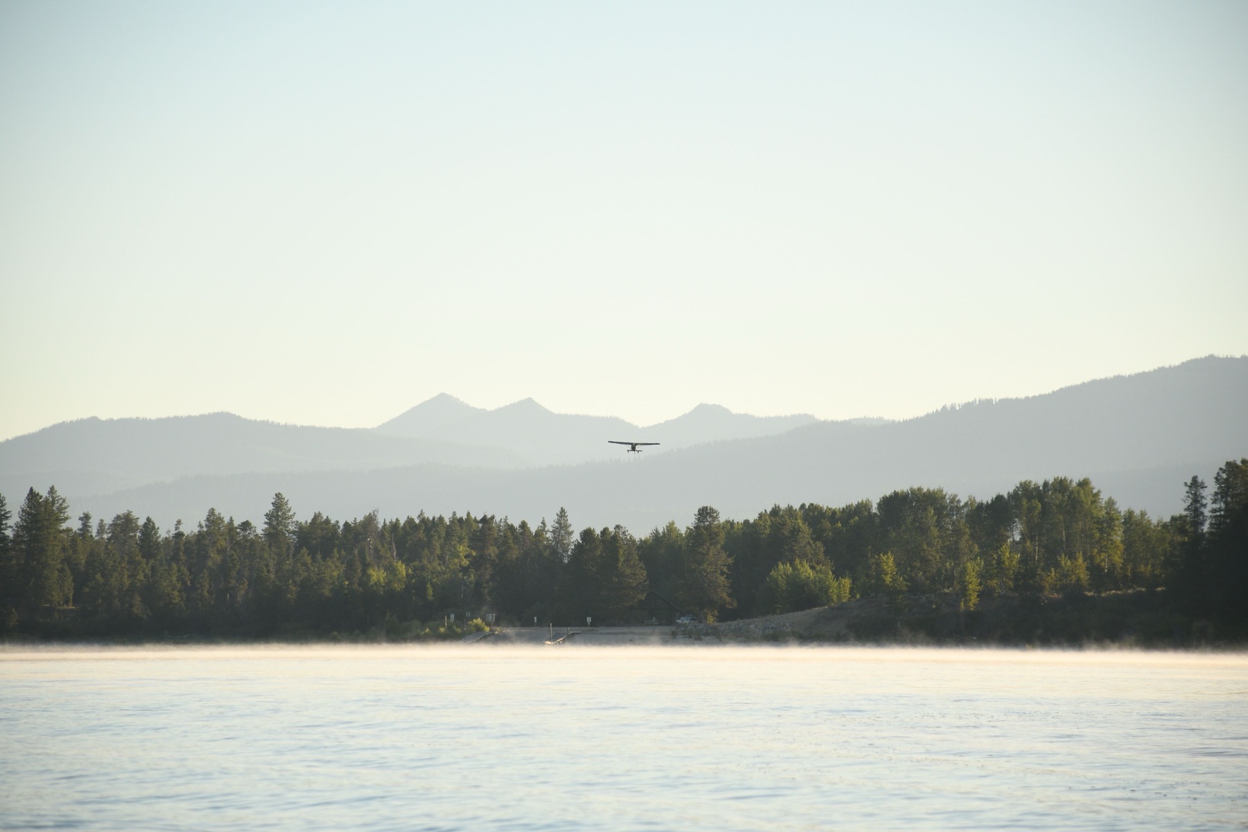Floatplane over a hazy lake in the Flathead Valley